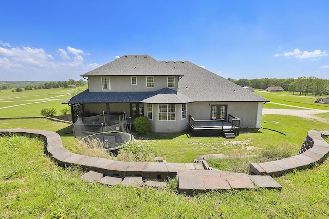 295 Headwaters Dr, Marshfield, MO 65706 - back of house featuring a trampoline, a yard, and a deck