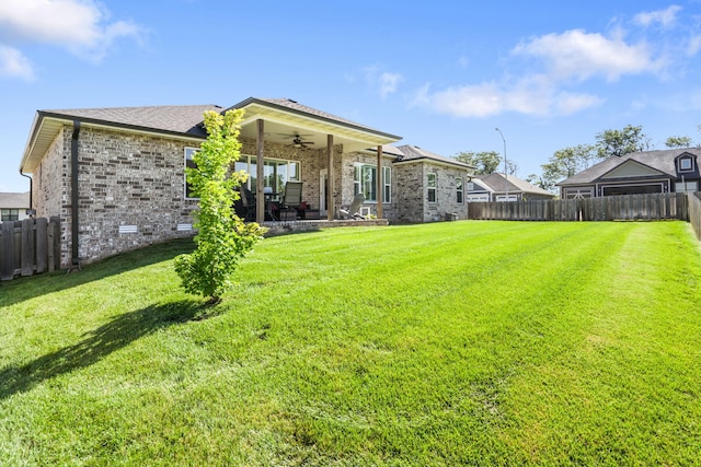 940 E Powers Ct, Nixa, MO 65714 - rear view of house with ceiling fan, a fenced backyard, brick siding, and a patio