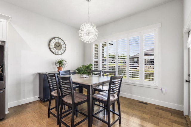 940 E Powers Ct, Nixa, MO 65714 - dining area featuring plenty of natural light, a chandelier, and wood finished floors