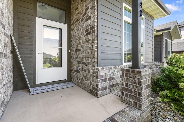 940 E Powers Ct, Nixa, MO 65714 - view of exterior entry featuring brick siding