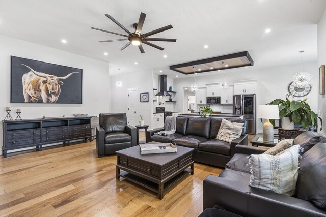 940 E Powers Ct, Nixa, MO 65714 - living area featuring ceiling fan, light wood-style floors, and a chandelier