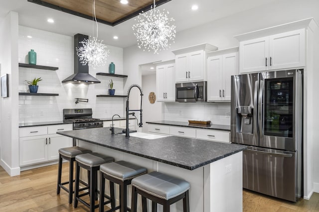 940 E Powers Ct, Nixa, MO 65714 - kitchen with appliances with stainless steel finishes, open shelves, exhaust hood, dark countertops, and recessed lighting