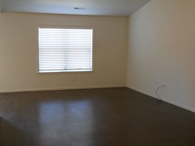 424 Echo Valley Cir, Reeds Spring, MO 65737 - unfurnished room with baseboards and dark wood-type flooring