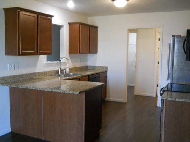 424 Echo Valley Cir, Reeds Spring, MO 65737 - kitchen featuring light stone counters, a peninsula, freestanding refrigerator, dark wood-type flooring, and dishwasher