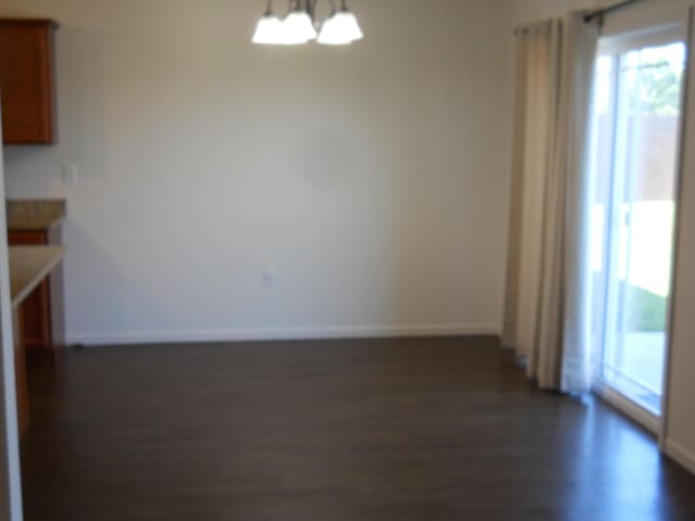 424 Echo Valley Cir, Reeds Spring, MO 65737 - unfurnished dining area featuring a chandelier and dark wood-type flooring