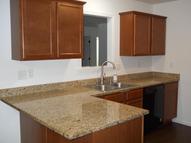 424 Echo Valley Cir, Reeds Spring, MO 65737 - kitchen with black dishwasher, a peninsula, light stone countertops, dark wood finished floors, and brown cabinets