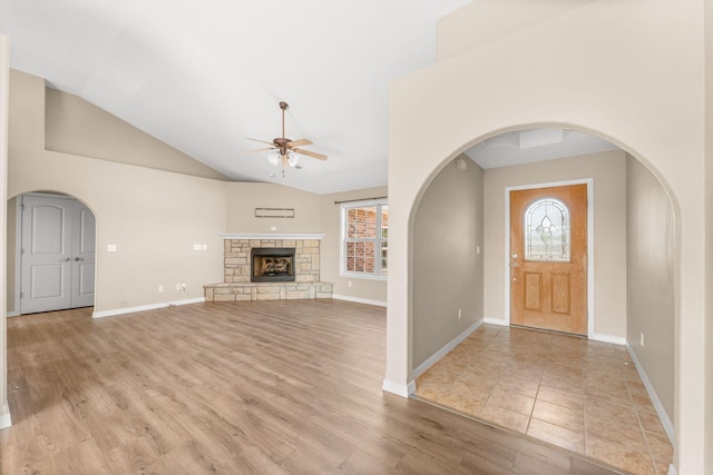 663 N Althea Ave, Nixa, MO 65714 - foyer entrance featuring ceiling fan, arched walkways, high vaulted ceiling, light wood-style floors, and a fireplace
