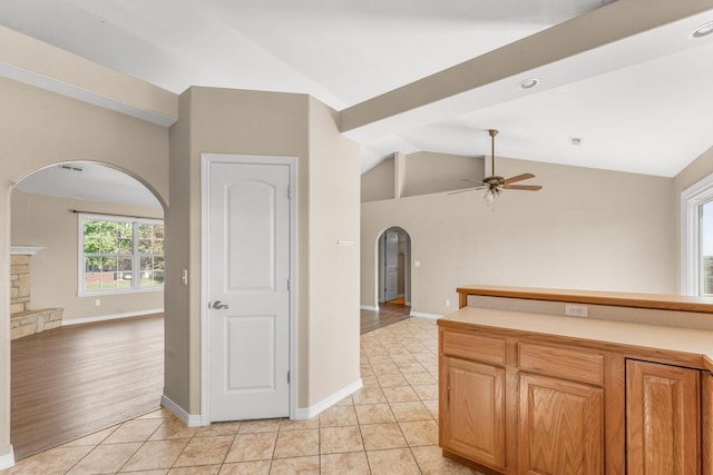 663 N Althea Ave, Nixa, MO 65714 - kitchen with arched walkways, open floor plan, ceiling fan, vaulted ceiling, and light tile patterned floors