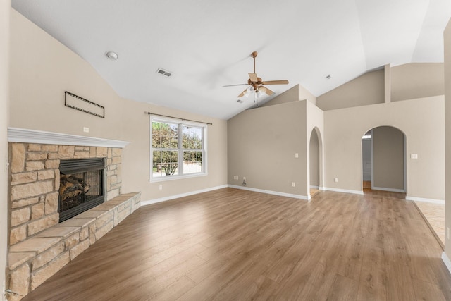 663 N Althea Ave, Nixa, MO 65714 - unfurnished living room featuring lofted ceiling, ceiling fan, light wood-style flooring, a fireplace, and arched walkways