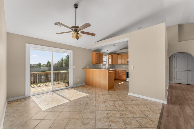 663 N Althea Ave, Nixa, MO 65714 - kitchen with a peninsula, arched walkways, a ceiling fan, light countertops, and decorative light fixtures