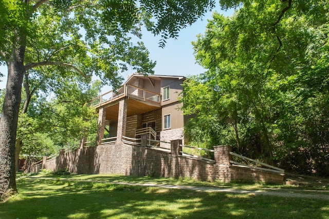 23 Sweetwater Ln, Buffalo, MO 65622 - view of property exterior with a balcony, a lawn, and stone siding
