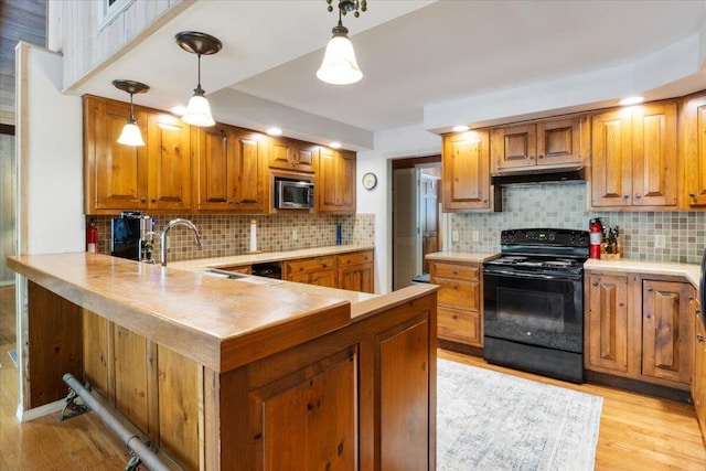 23 Sweetwater Ln, Buffalo, MO 65622 - kitchen with black electric range, stainless steel microwave, decorative backsplash, and light wood-style floors