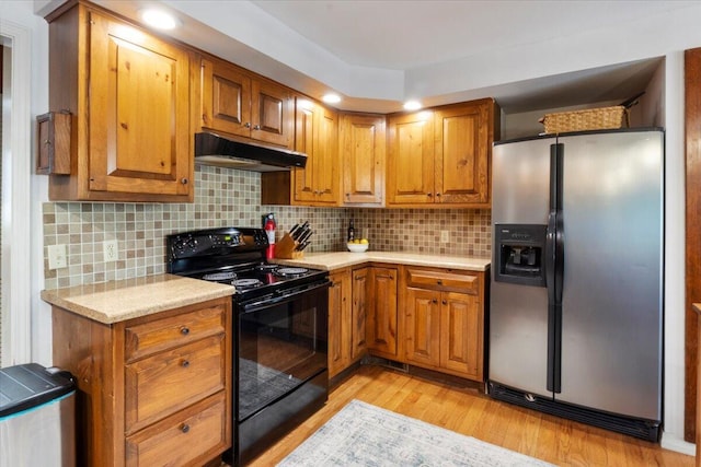 23 Sweetwater Ln, Buffalo, MO 65622 - kitchen featuring stainless steel refrigerator with ice dispenser, black / electric stove, under cabinet range hood, light countertops, and brown cabinets