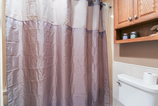 23 Sweetwater Ln, Buffalo, MO 65622 - bathroom with wainscoting, tile walls, and a shower with curtain