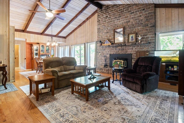 23 Sweetwater Ln, Buffalo, MO 65622 - living room featuring high vaulted ceiling, wood finished floors, a brick fireplace, wooden walls, and ceiling fan