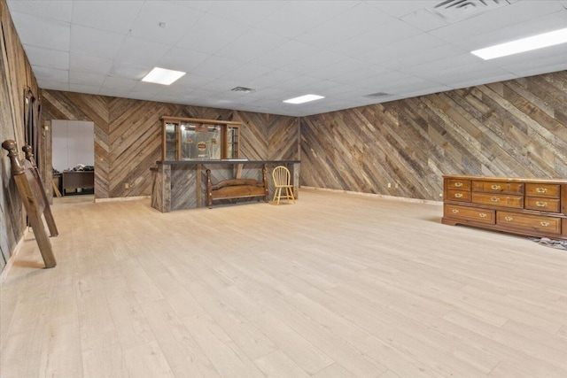 23 Sweetwater Ln, Buffalo, MO 65622 - basement with wooden walls, light wood-style flooring, and a paneled ceiling