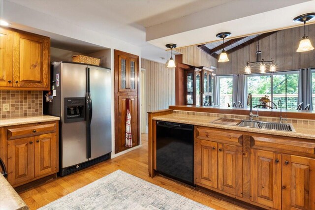 23 Sweetwater Ln, Buffalo, MO 65622 - kitchen with black dishwasher, stainless steel fridge, brown cabinets, decorative backsplash, and decorative light fixtures