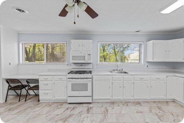 433 Old Aurora Rd, Verona, MO 65769 - kitchen with white appliances, light countertops, white cabinetry, and ornamental molding