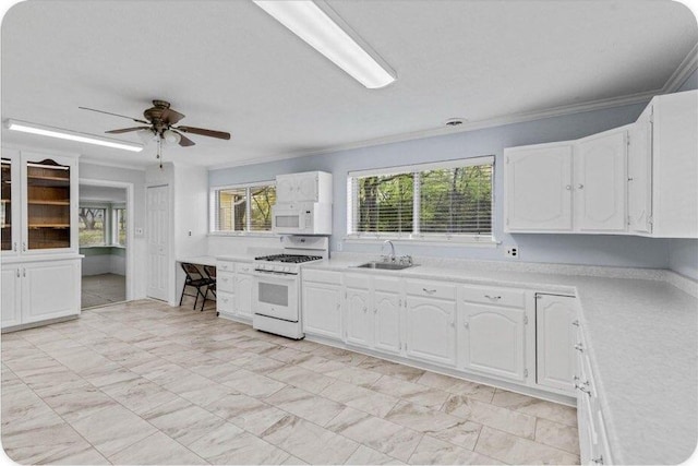 433 Old Aurora Rd, Verona, MO 65769 - kitchen featuring white appliances, light countertops, crown molding, white cabinets, and a ceiling fan