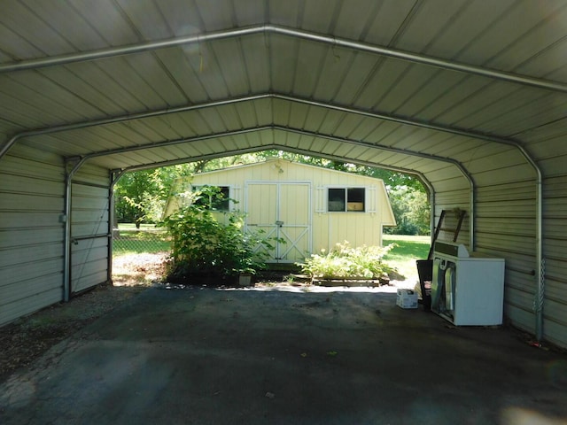 433 Old Aurora Rd, Verona, MO 65769 - view of vehicle parking featuring a detached carport and a storage unit