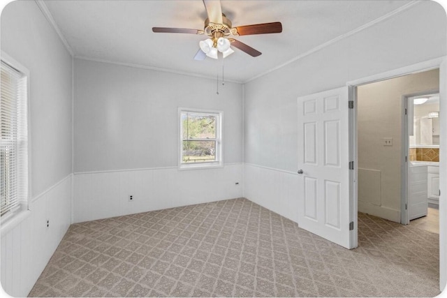 433 Old Aurora Rd, Verona, MO 65769 - unfurnished bedroom with light colored carpet, ornamental molding, wainscoting, and a ceiling fan