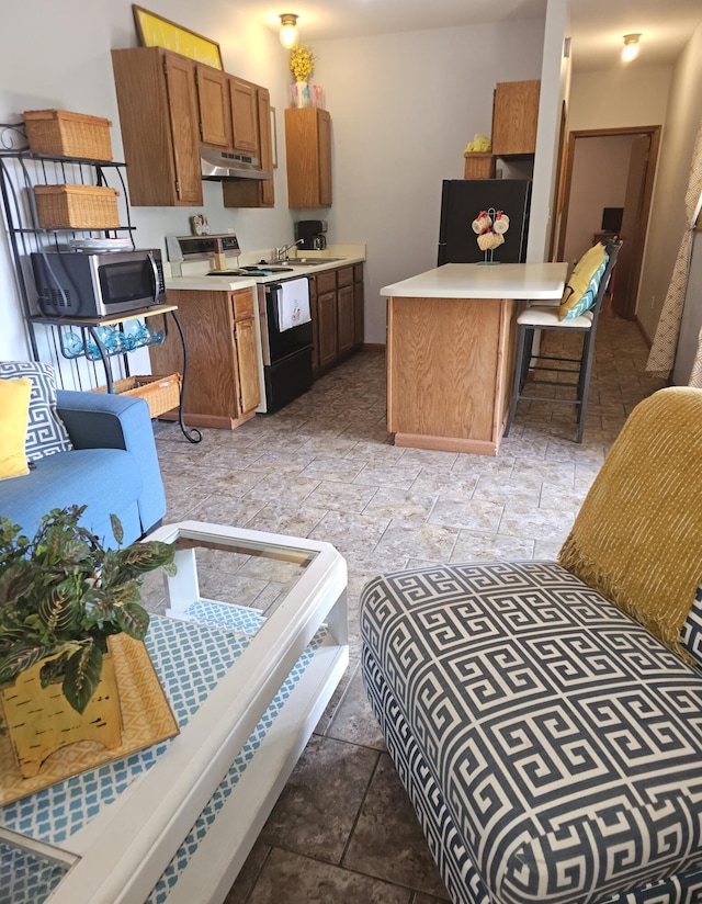 388 Notch Ln Bldg 5 Unit B, Branson West, MO 65737 - kitchen with range with electric stovetop, under cabinet range hood, freestanding refrigerator, stainless steel microwave, and light countertops