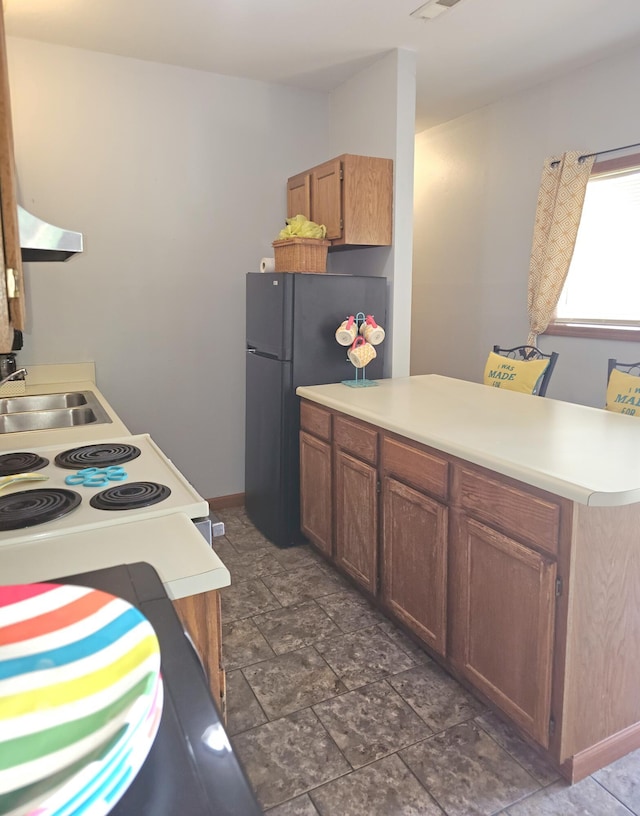388 Notch Ln Bldg 5 Unit B, Branson West, MO 65737 - kitchen featuring a peninsula, electric stove, freestanding refrigerator, light countertops, and dark stone finish flooring