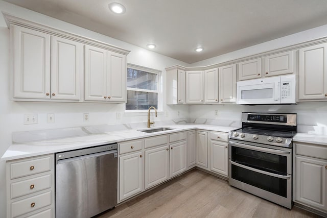 903 N 4th St, Ozark, MO 65721 - kitchen with appliances with stainless steel finishes, light wood finished floors, light stone counters, and recessed lighting