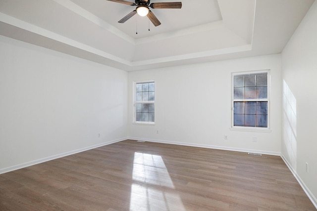 903 N 4th St, Ozark, MO 65721 - empty room featuring ceiling fan, a raised ceiling, and wood finished floors