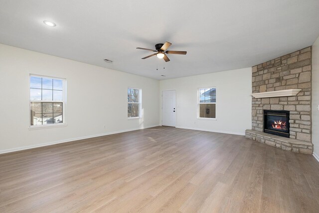 903 N 4th St, Ozark, MO 65721 - unfurnished living room with ceiling fan, wood finished floors, and a fireplace