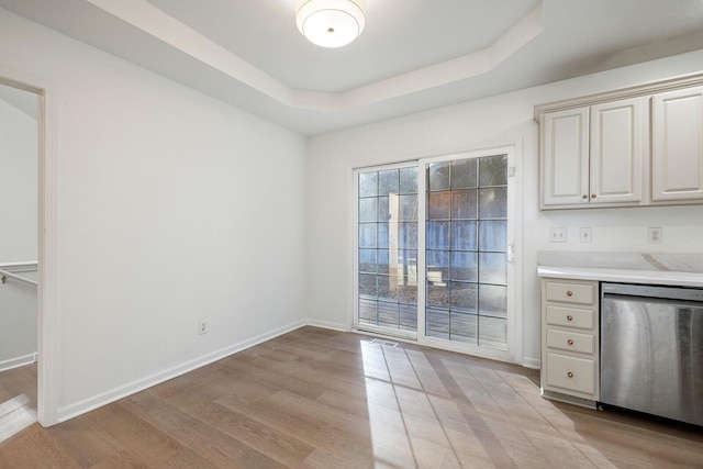 903 N 4th St, Ozark, MO 65721 - unfurnished dining area with light wood finished floors and a tray ceiling