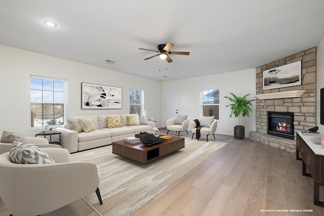 903 N 4th St, Ozark, MO 65721 - living room with a ceiling fan, wood finished floors, and a fireplace