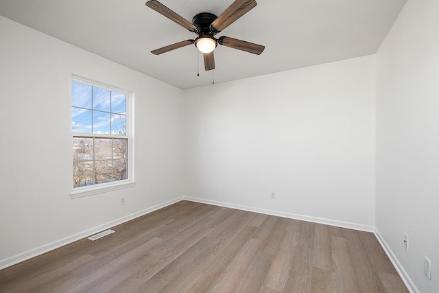 903 N 4th St, Ozark, MO 65721 - empty room with wood finished floors and a ceiling fan