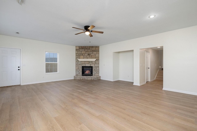 903 N 4th St, Ozark, MO 65721 - unfurnished living room with ceiling fan, light wood-style floors, and a fireplace