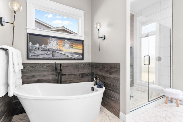 3972 E Dunrobin Dr, Springfield, MO 65809 - full bathroom featuring marble look tiles, a freestanding tub, and a shower stall