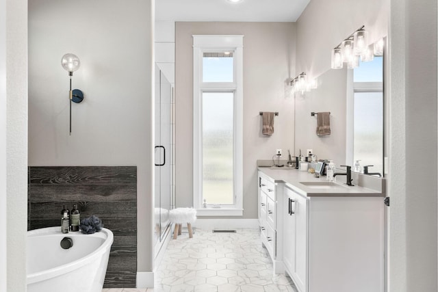 3972 E Dunrobin Dr, Springfield, MO 65809 - bathroom with double vanity, a freestanding tub, a shower stall, and plenty of natural light