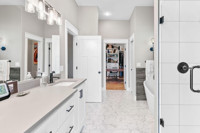 3972 E Dunrobin Dr, Springfield, MO 65809 - ensuite bathroom with vanity, a freestanding tub, marble look tile flooring, and a closet