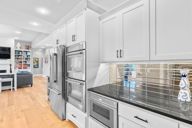 3972 E Dunrobin Dr, Springfield, MO 65809 - kitchen featuring appliances with stainless steel finishes, open floor plan, white cabinets, light wood finished floors, and recessed lighting
