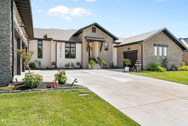 3972 E Dunrobin Dr, Springfield, MO 65809 - view of front facade with a garage, driveway, a front yard, and brick siding