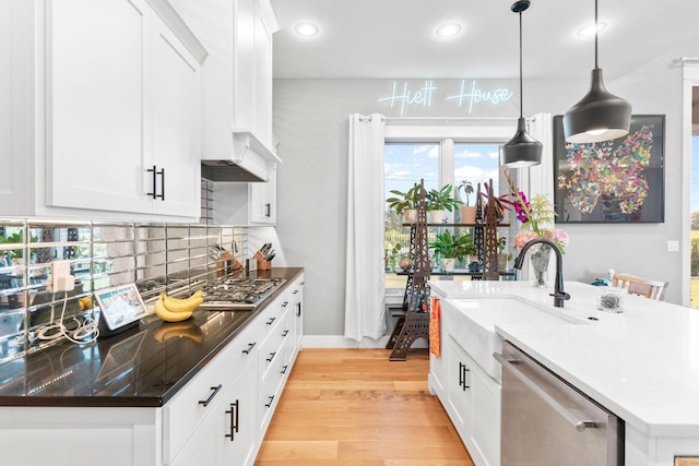 3972 E Dunrobin Dr, Springfield, MO 65809 - kitchen featuring appliances with stainless steel finishes, backsplash, recessed lighting, light wood-style floors, and an island with sink