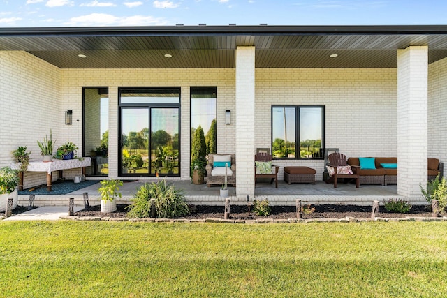 3972 E Dunrobin Dr, Springfield, MO 65809 - property entrance featuring a lawn, an outdoor living space, and brick siding