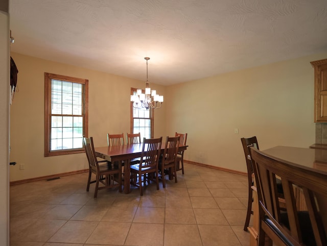 6092 W Farm Rd Unit 114, Springfield, MO 65802 - dining space featuring a chandelier and light tile patterned flooring
