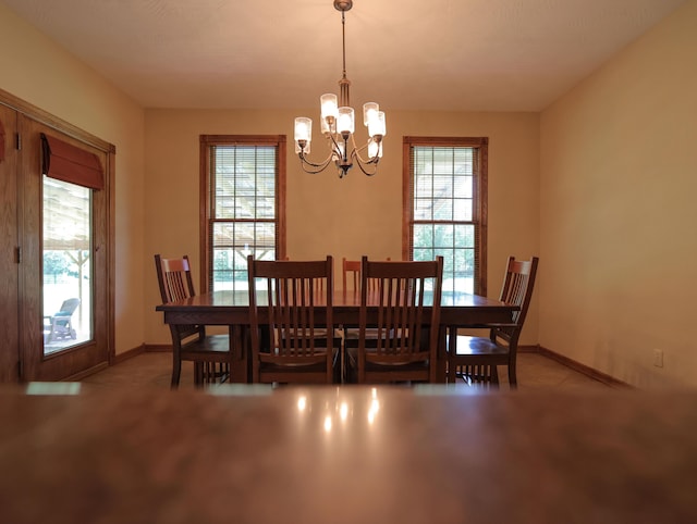 6092 W Farm Rd Unit 114, Springfield, MO 65802 - dining room with a chandelier and baseboards