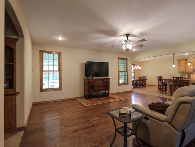 6092 W Farm Rd Unit 114, Springfield, MO 65802 - living room featuring arched walkways, ceiling fan, a chandelier, wood finished floors, and recessed lighting