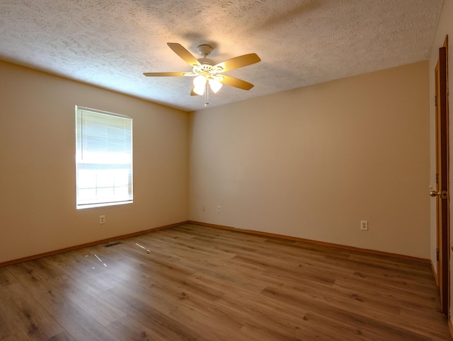 1324 N Forest Ave, Springfield, MO 65802 - unfurnished room with wood finished floors, a ceiling fan, and a textured ceiling