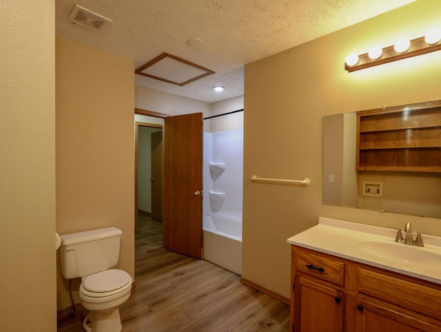 1324 N Forest Ave, Springfield, MO 65802 - full bathroom with wood finished floors, vanity, washtub / shower combination, and a textured ceiling