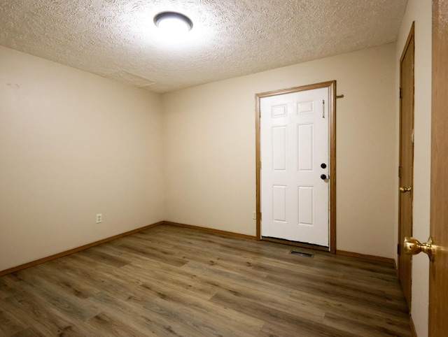 1324 N Forest Ave, Springfield, MO 65802 - empty room with wood finished floors and a textured ceiling