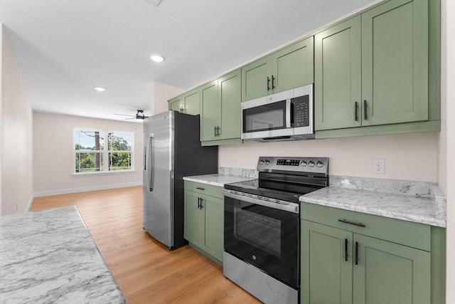 265 Mccann Rd, Powersite, MO 65731 - kitchen with green cabinets, appliances with stainless steel finishes, light countertops, light wood-style floors, and a ceiling fan