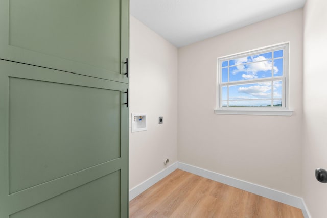 265 Mccann Rd, Powersite, MO 65731 - laundry area featuring hookup for an electric dryer, light wood-style floors, hookup for a washing machine, and cabinet space