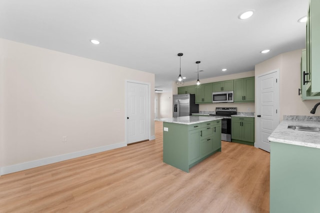 265 Mccann Rd, Powersite, MO 65731 - kitchen featuring green cabinetry, stainless steel appliances, a kitchen island, light wood-type flooring, and hanging light fixtures
